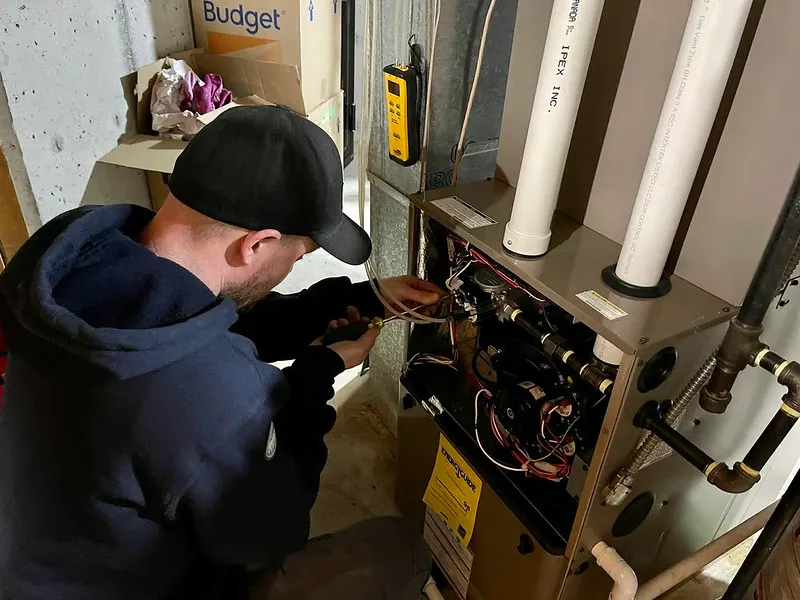 HVAC technician inspecting unit
